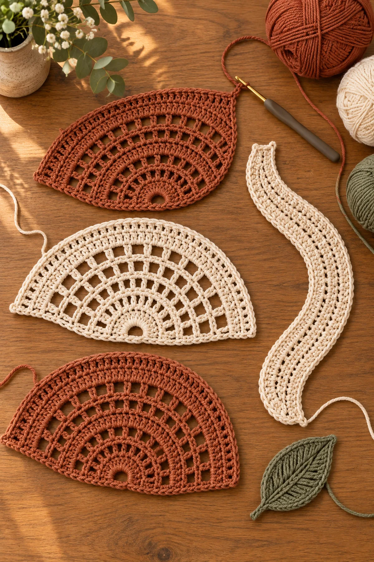 Terracotta solid half fans and cream crochet lace fans in counted construction stages