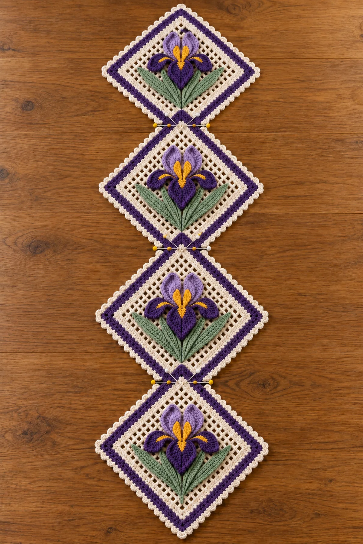 Four purple crochet iris flowers twelve sage leaves and four stems arranged before panel assembly